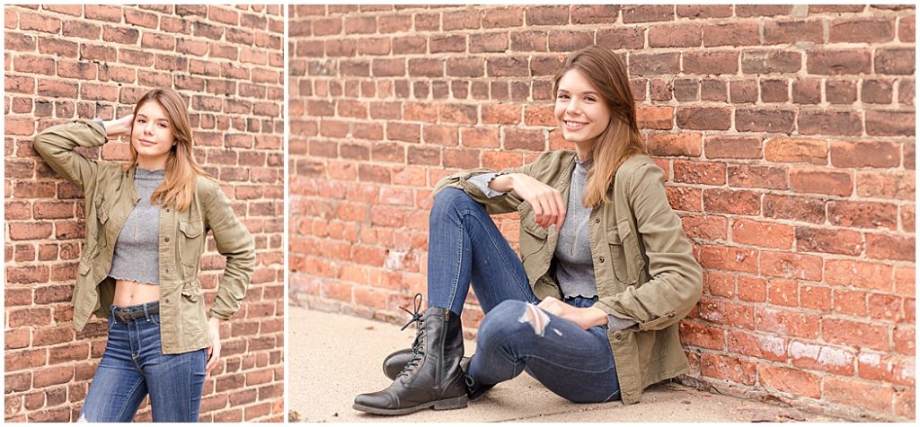 girl senior pictures in front of brick wall