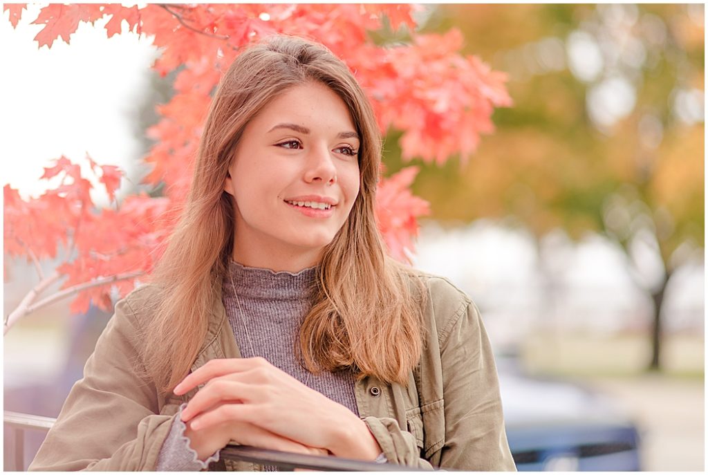 girl senior pictures by red maple tree